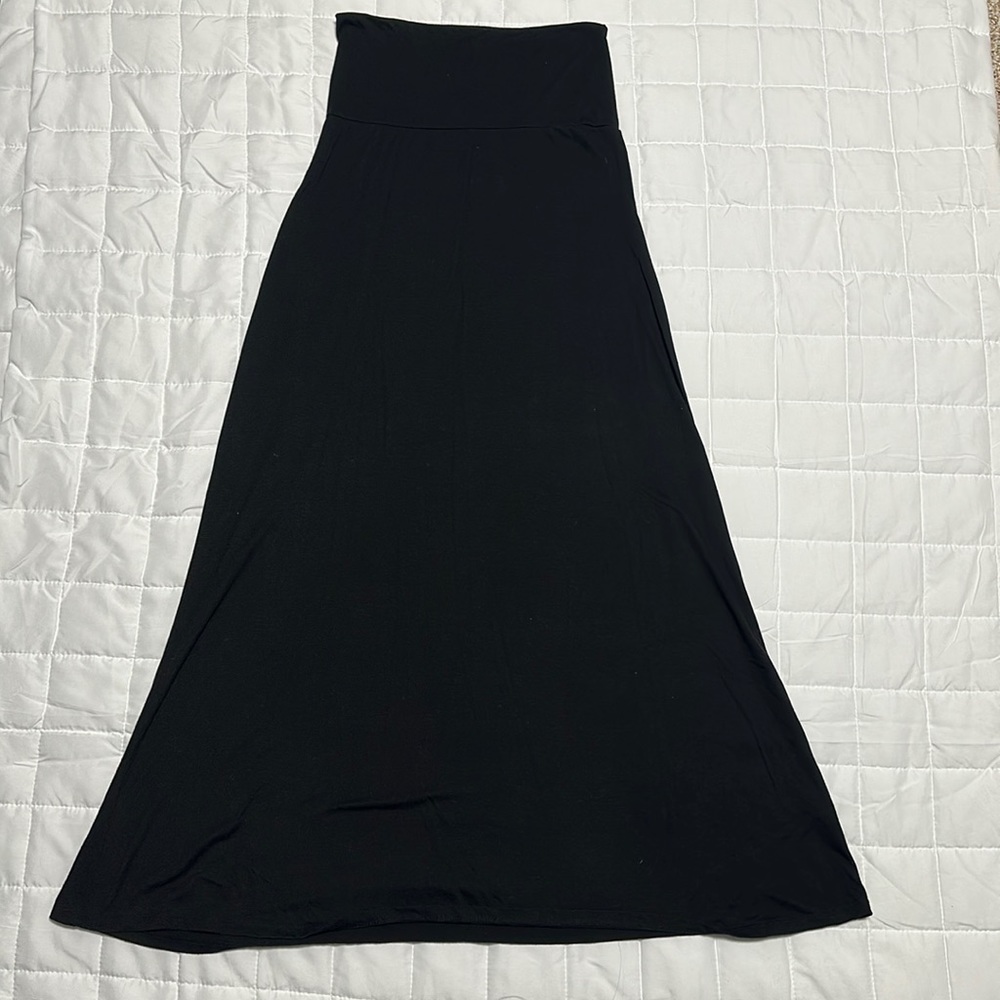 Floor length, high waisted black skirt.